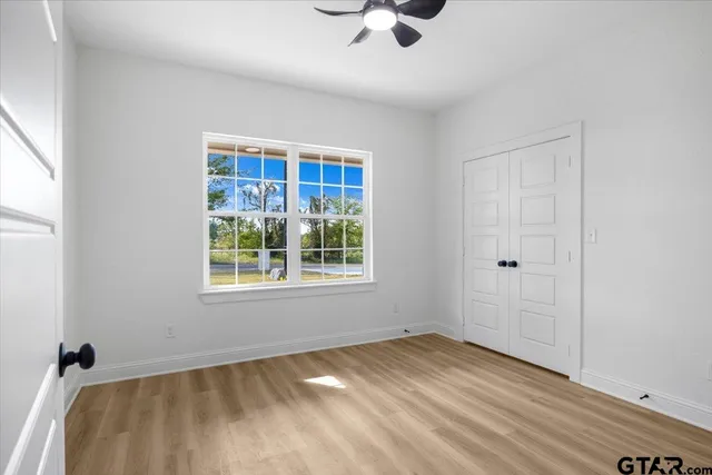 a view of a room with wooden floor