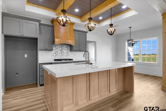 a kitchen with a sink and a stove top oven
