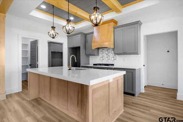 a kitchen with a sink and chandelier