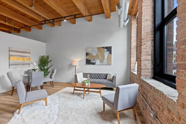 a living room with furniture and a potted plant
