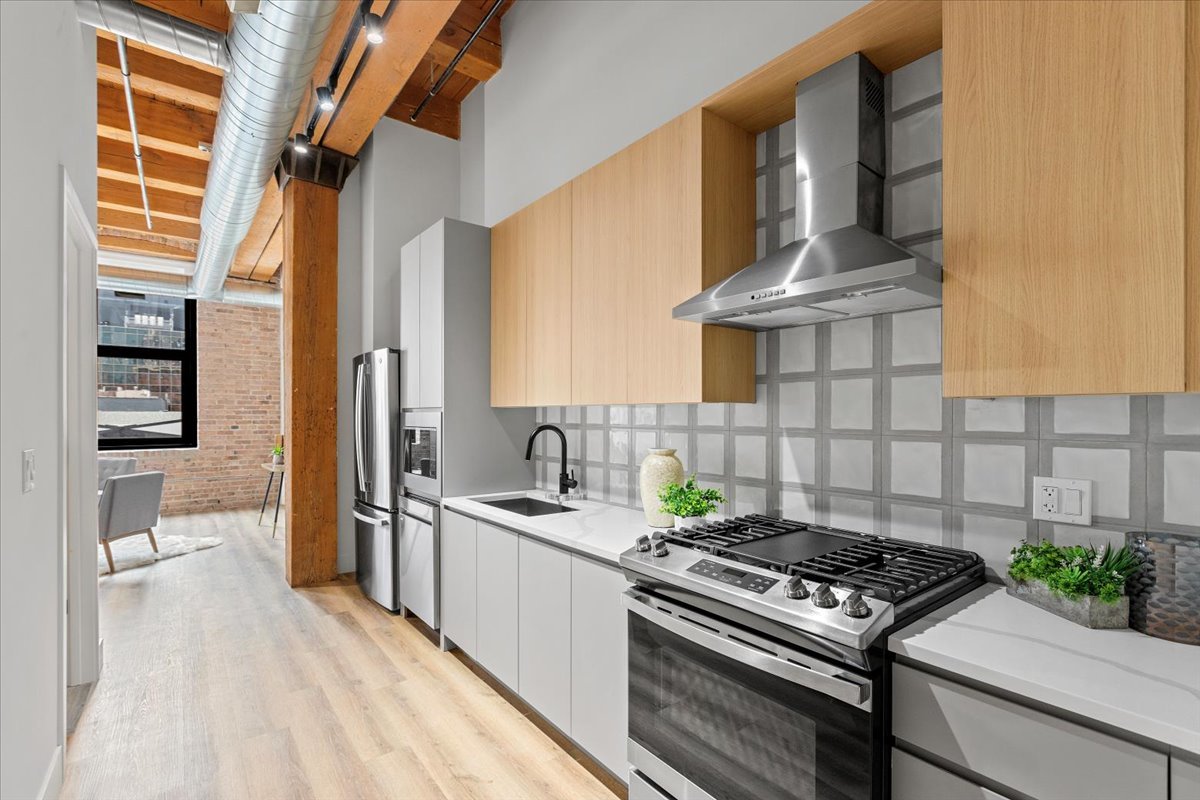 153 West Ohio Street, Unit 202 Chicago, IL 60654 - Photo 10 of 11 a kitchen with a stove and a white wooden cabinets