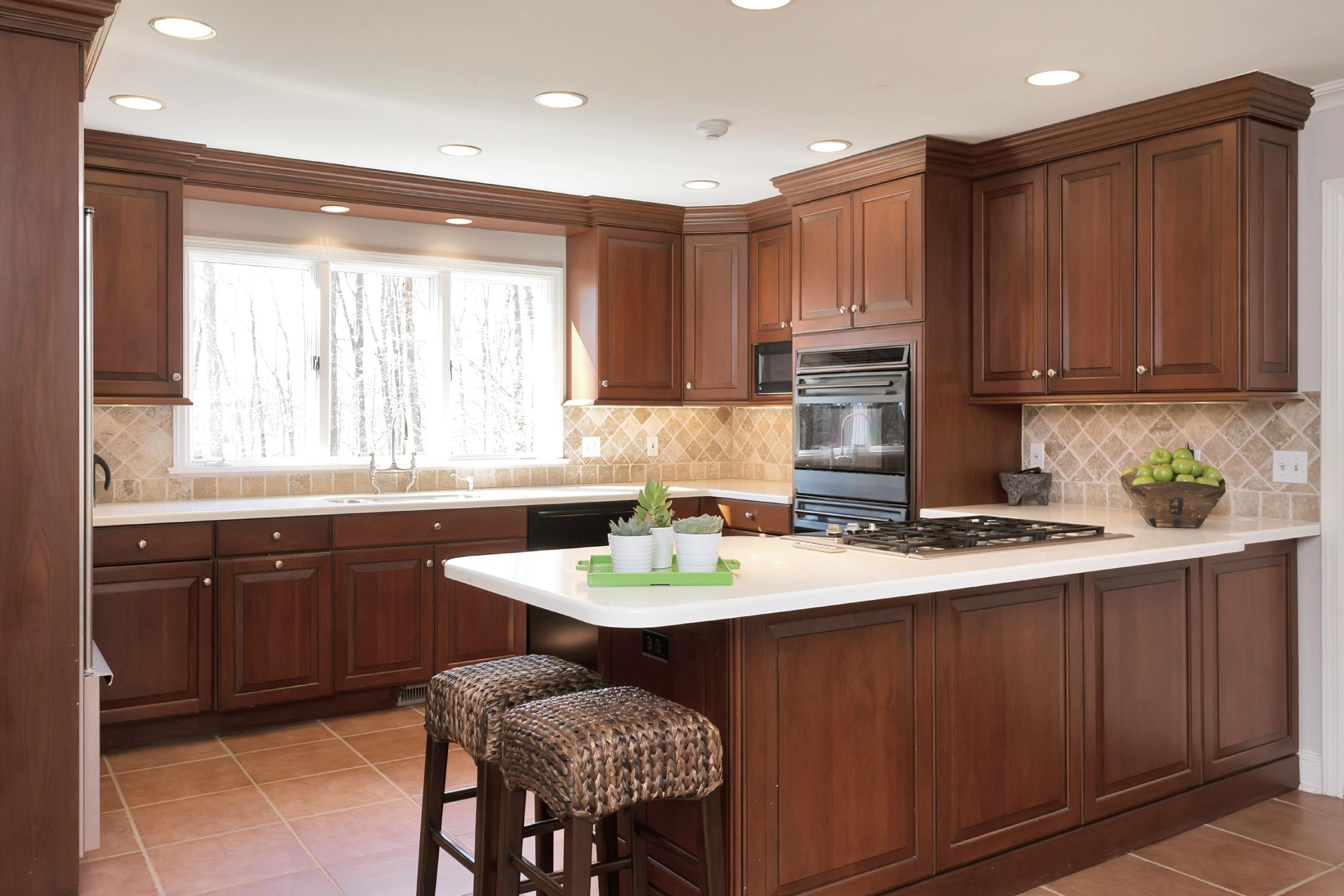483 Middlesex Road Darien, CT 06820 - Photo 11 of 27 a kitchen with kitchen island granite countertop a sink a stove a dining table and chairs