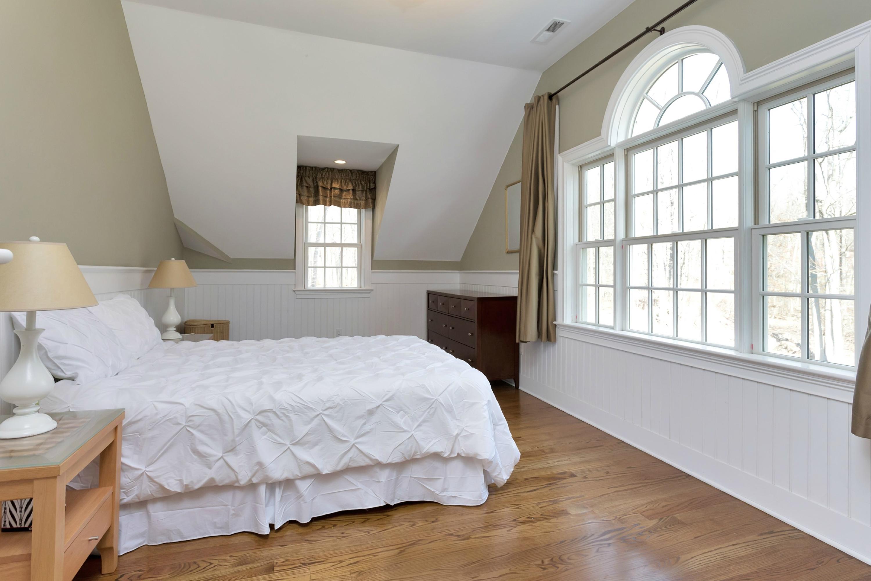 483 Middlesex Road Darien, CT 06820 - Photo 23 of 27 a bedroom with a bed and a large window