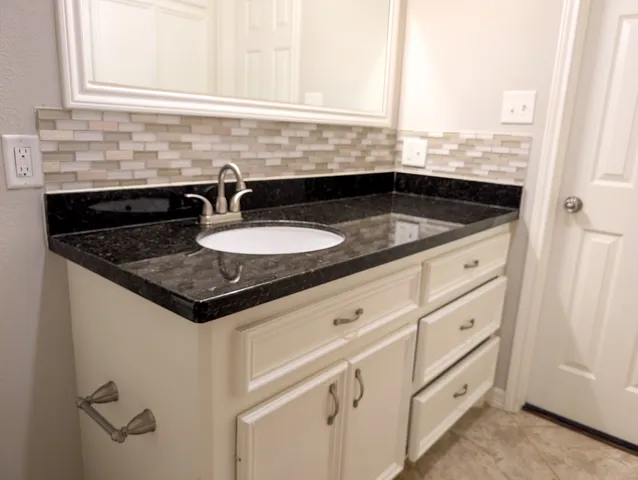 a bathroom with a sink and a window