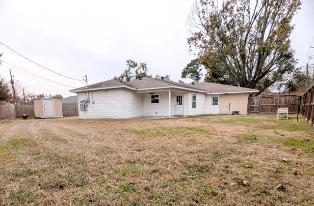 a outdoor space with a house in the background