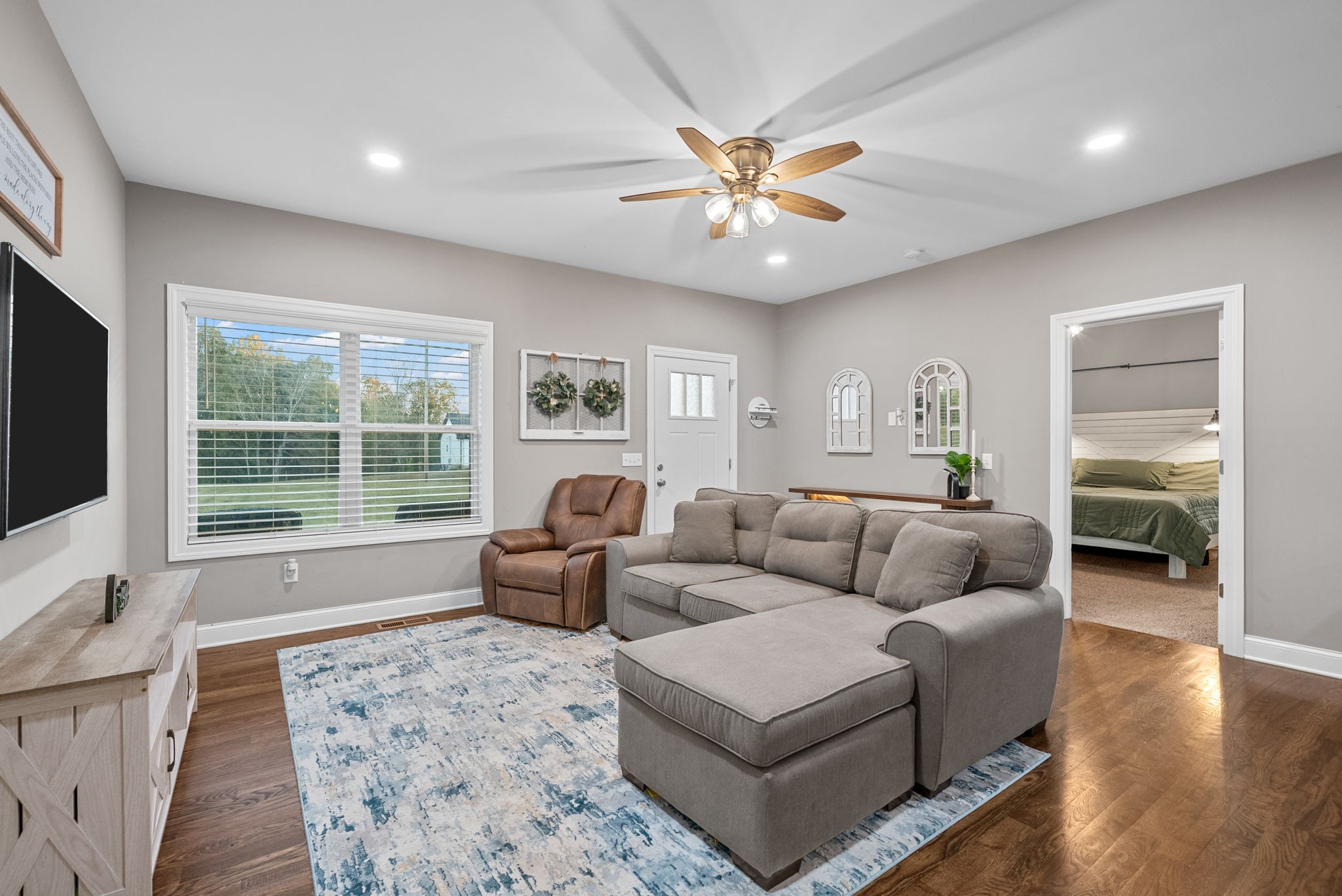 3762 Bowker Road Charlotte, TN 37036 - Photo 12 of 35 a living room with furniture and a flat screen tv