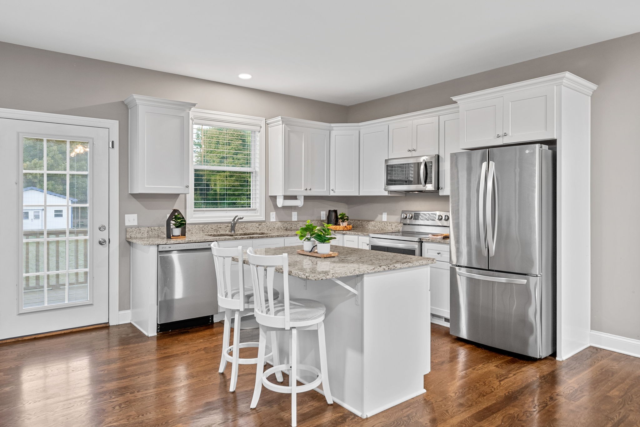 3762 Bowker Road Charlotte, TN 37036 - Photo 14 of 35 a kitchen with stainless steel appliances granite countertop a refrigerator a stove a sink a dining table and chairs