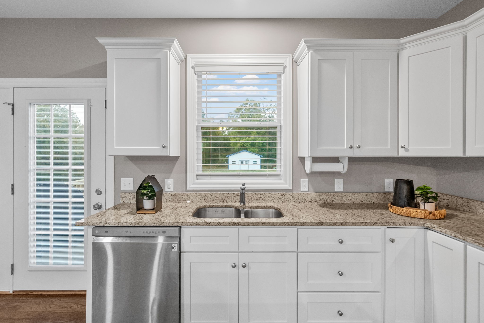 3762 Bowker Road Charlotte, TN 37036 - Photo 17 of 35 a kitchen with stainless steel appliances granite countertop white cabinets and a window