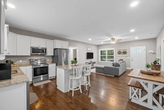 a bedroom with a bed dresser and a window
