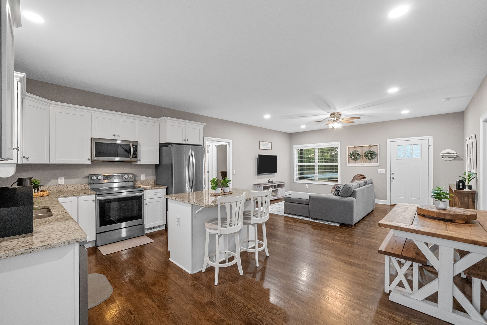 3762 Bowker Road Charlotte, TN 37036 - Photo 18 of 35 a living room with stainless steel appliances furniture and a wooden floor