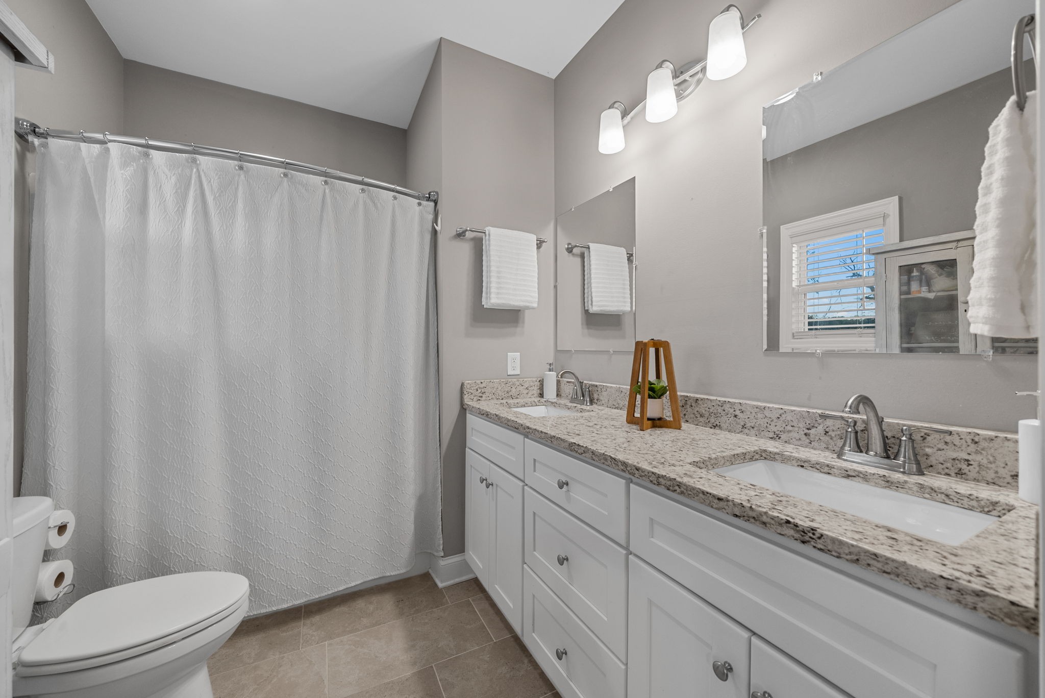 3762 Bowker Road Charlotte, TN 37036 - Photo 20 of 35 a bathroom with a granite countertop sink and a mirror