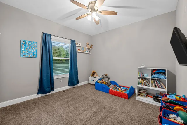 a bathroom with a granite countertop sink a toilet and a mirror