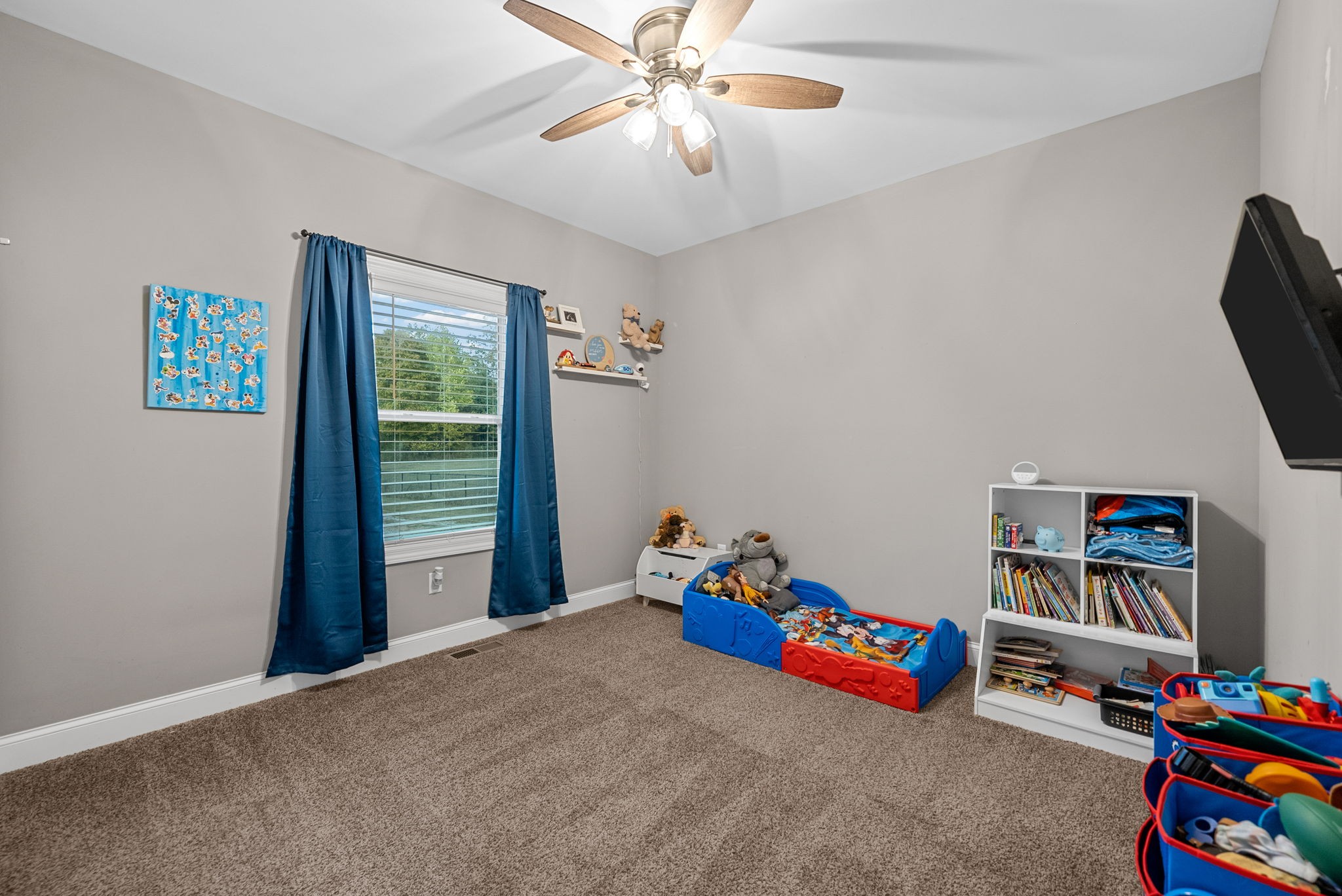 3762 Bowker Road Charlotte, TN 37036 - Photo 21 of 35 a bedroom with furniture and a fan