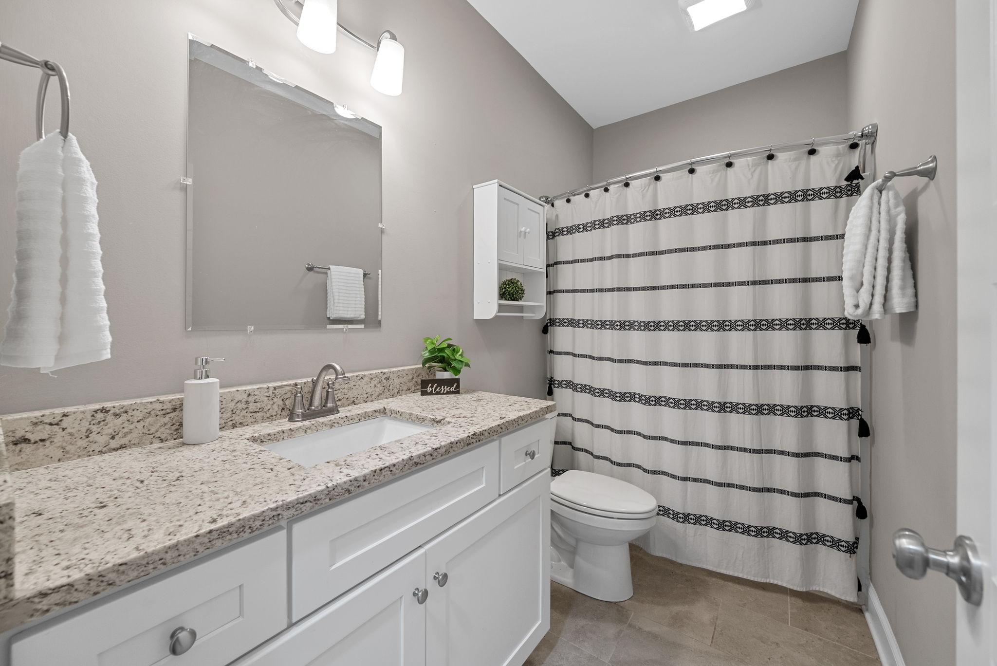 3762 Bowker Road Charlotte, TN 37036 - Photo 22 of 35 a bathroom with a granite countertop sink a toilet and a mirror