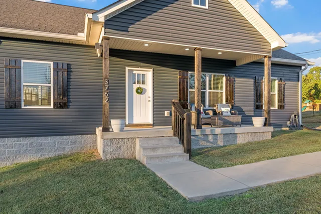 a view of a house with a yard and garage