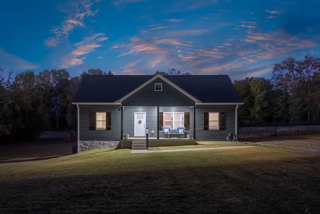 a front view of house with yard and green space