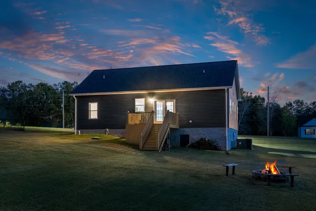 a backyard of a house with table and chairs