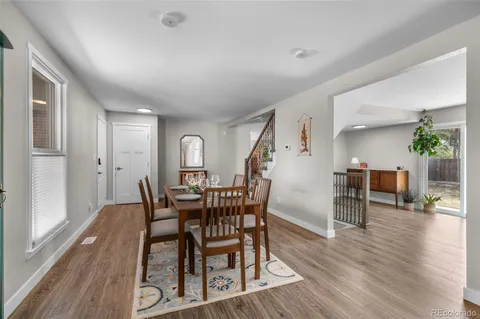 a view of a dining room with furniture and wooden floor
