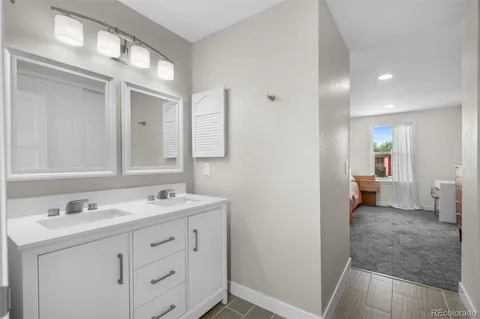 a spacious bathroom with a sink and a mirror