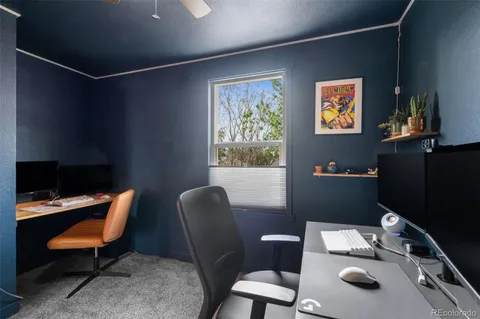 a work room with furniture and a wooden floor