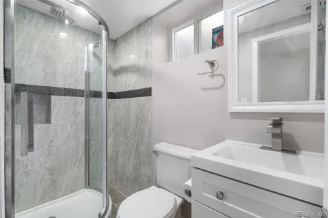 a bathroom with a sink toilet and shower