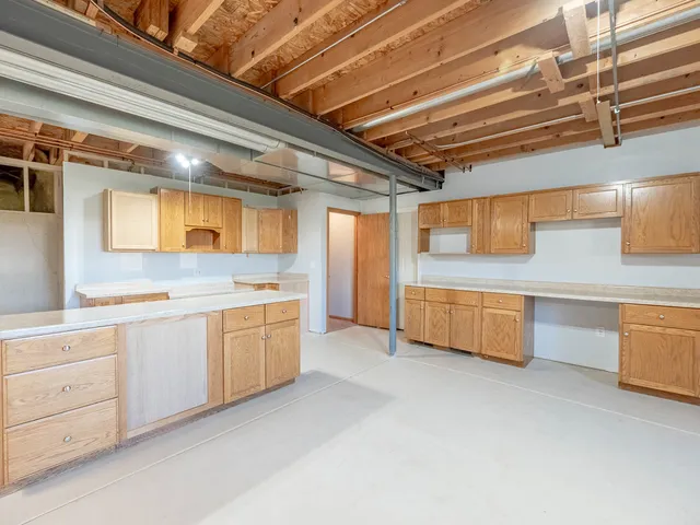 a kitchen with white cabinets and white appliances