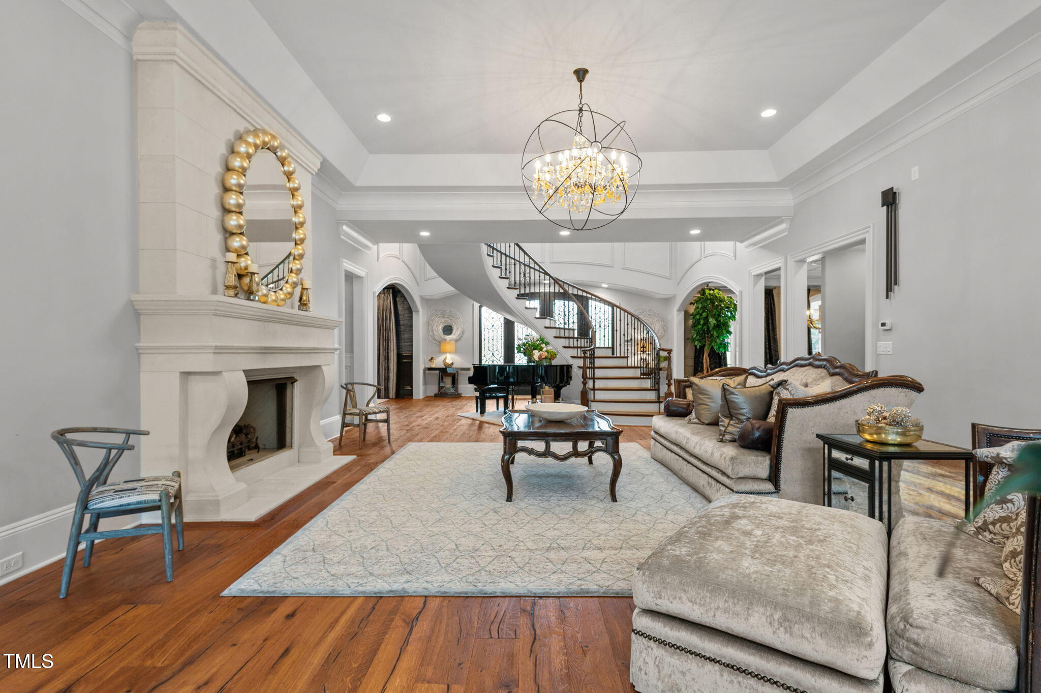 12660 Boyce Mill Road Raleigh, NC 27613 - Photo 11 of 89 a view of a livingroom with furniture a fireplace wooden floor and chandelier
