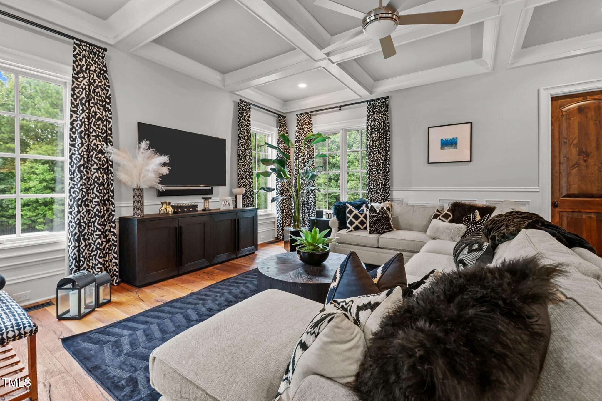 12660 Boyce Mill Road Raleigh, NC 27613 - Photo 13 of 89 a living room with furniture a flat screen tv and a floor to ceiling window