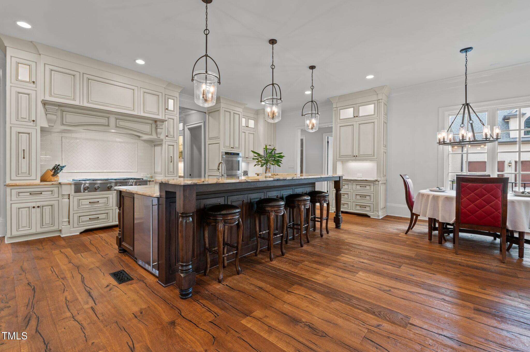 12660 Boyce Mill Road Raleigh, NC 27613 - Photo 14 of 89 a large kitchen with lots of counter space a sink appliances and dining table
