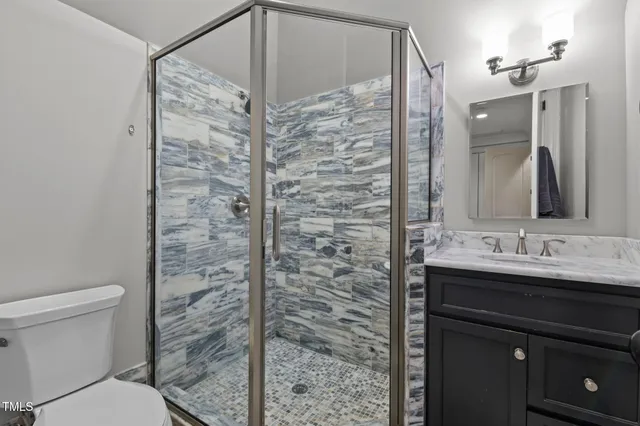 a view of a patio with couches a table and chairs with wooden fence