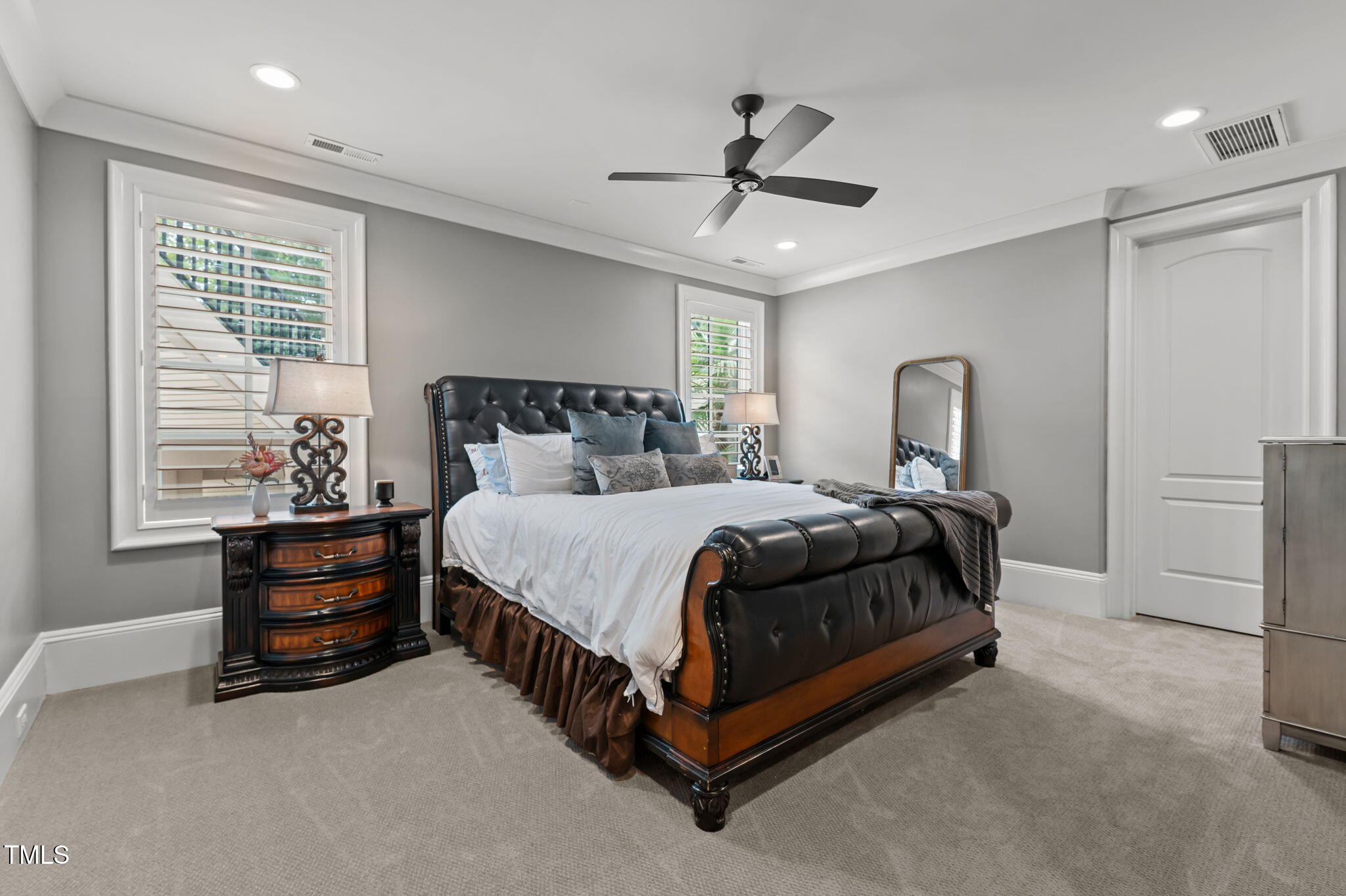 12660 Boyce Mill Road Raleigh, NC 27613 - Photo 40 of 89 a bedroom with a bed and a chandelier