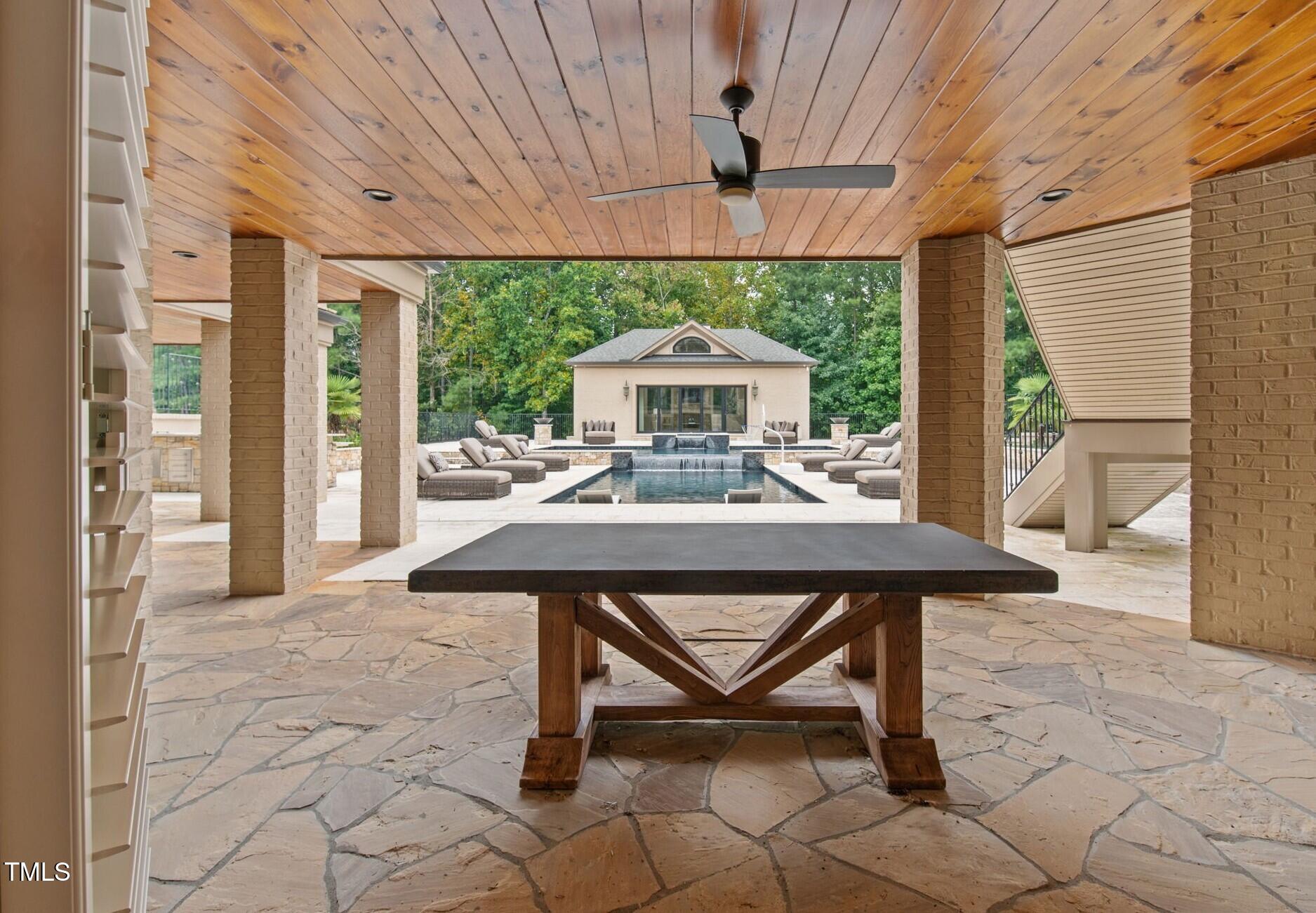12660 Boyce Mill Road Raleigh, NC 27613 - Photo 65 of 89 a view of a patio with a table chairs and a small yard