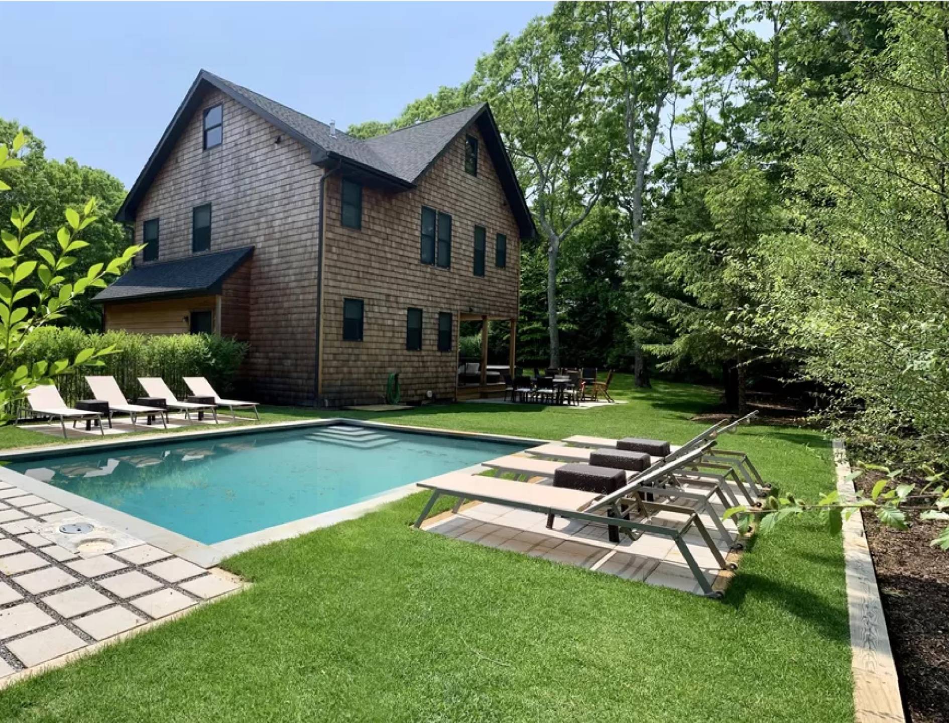 a view of a house with backyard sitting area and garden
