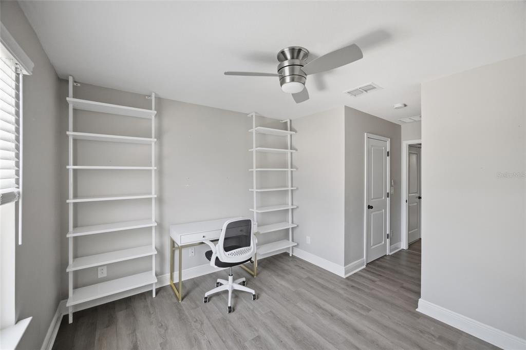 2013 Sunset Wind Loop Oldsmar, FL 34677 - Photo 26 of 43 a view of a workspace with wooden floor closet and windows