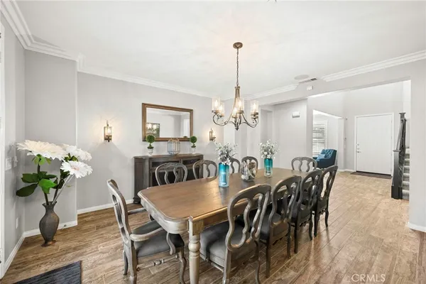 a view of a dining room with furniture and a chandelier