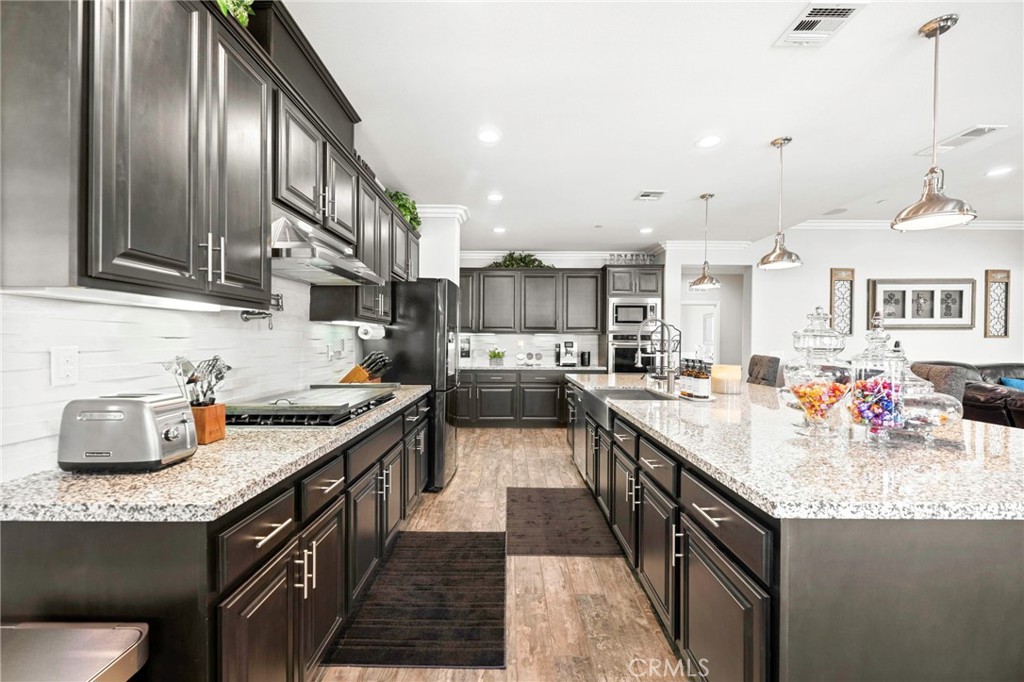 16555 Vía Los Caballeros Riverside, CA 92504 - Photo 14 of 51 a kitchen with granite countertop a sink stove and cabinets