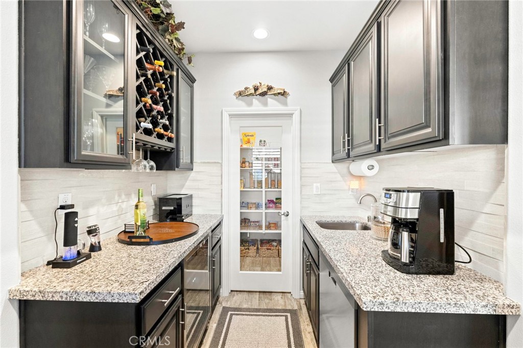 16555 Vía Los Caballeros Riverside, CA 92504 - Photo 17 of 51 a kitchen with granite countertop kitchen island stainless steel appliances a sink stove and cabinets