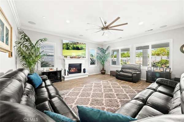 a living room with furniture fireplace and a large window
