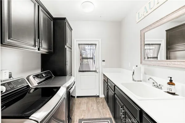 a kitchen with a sink stove and cabinets