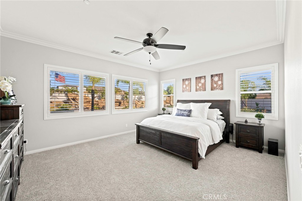 16555 Vía Los Caballeros Riverside, CA 92504 - Photo 21 of 51 a spacious bedroom with a large bed and a window