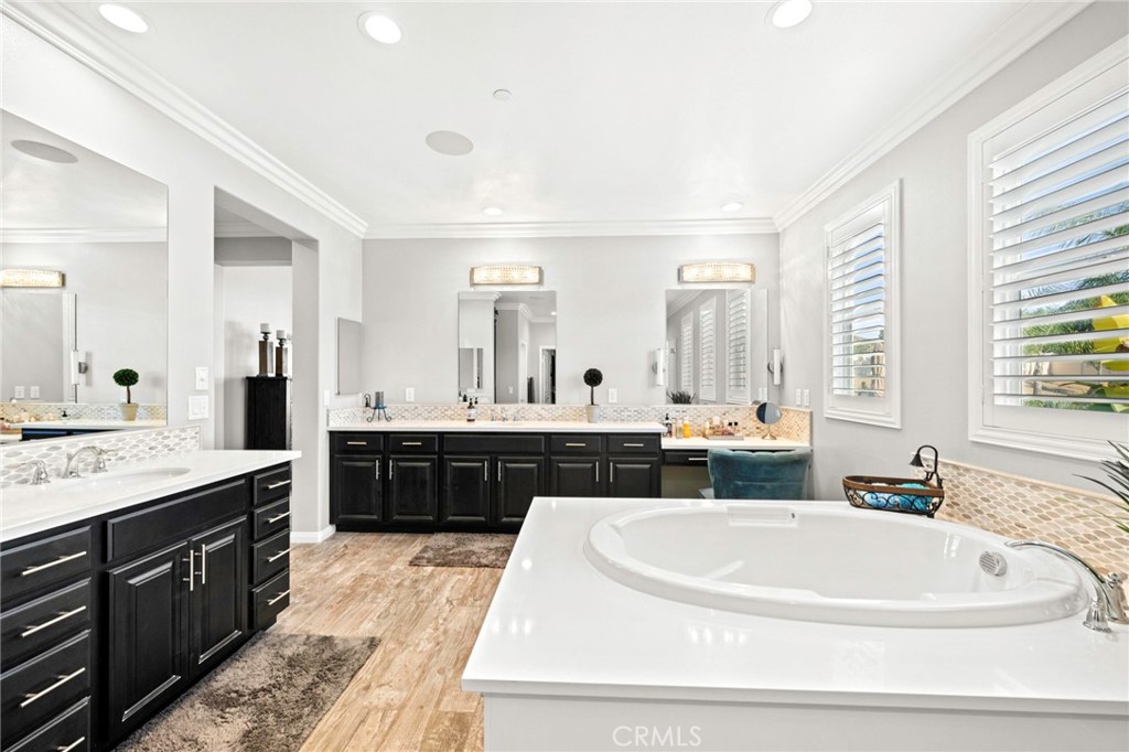 16555 Vía Los Caballeros Riverside, CA 92504 - Photo 22 of 51 a large bathroom with a double vanity sink a bathtub a mirror and vanity