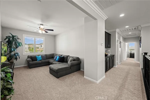 a living room with furniture and a chandelier