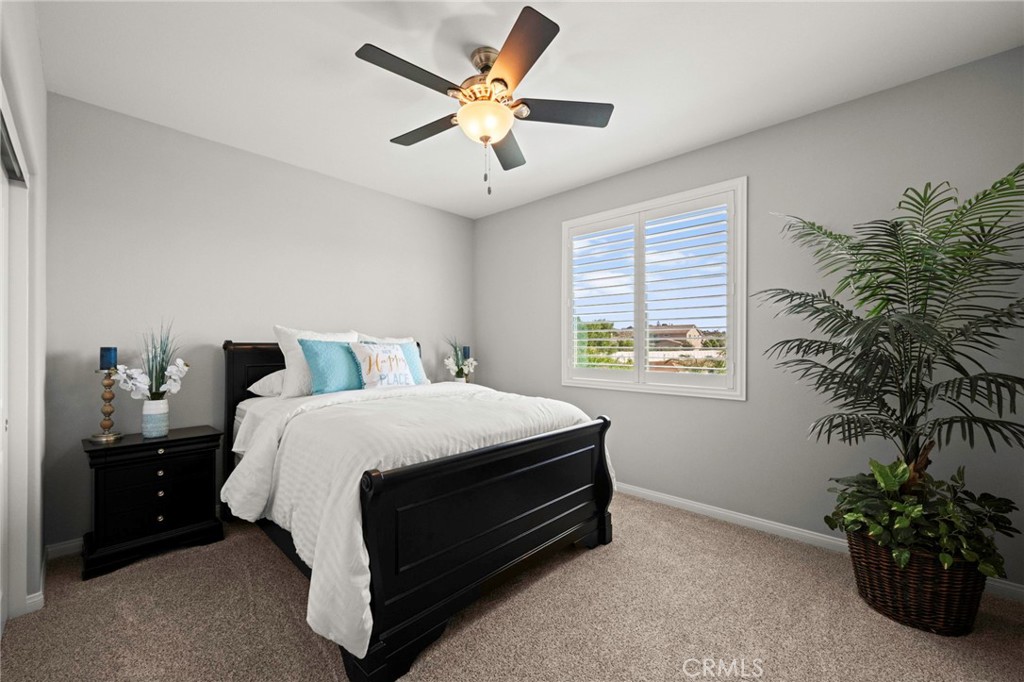 16555 Vía Los Caballeros Riverside, CA 92504 - Photo 27 of 51 a bedroom with a bed and a potted plant