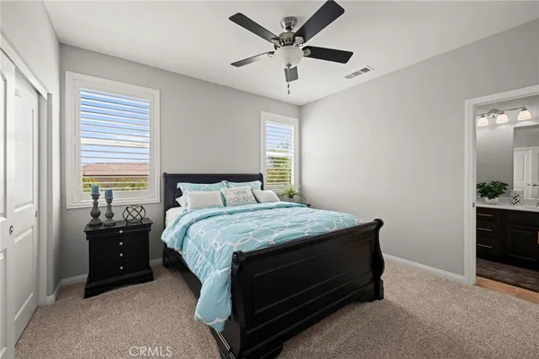 a bedroom with a bed and a potted plant