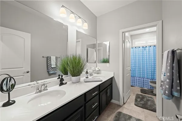 a bathroom with a double vanity sink a double vanity and a mirror