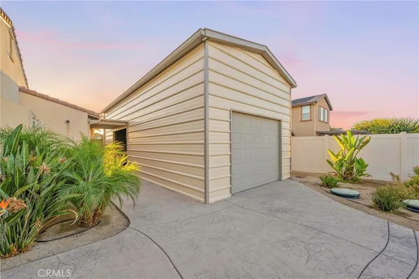 a view of a house with a yard and potted plants