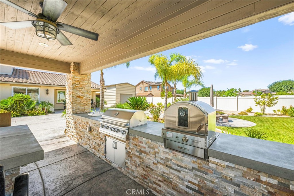 16555 Vía Los Caballeros Riverside, CA 92504 - Photo 41 of 51 a living room with furniture and a floor to ceiling window