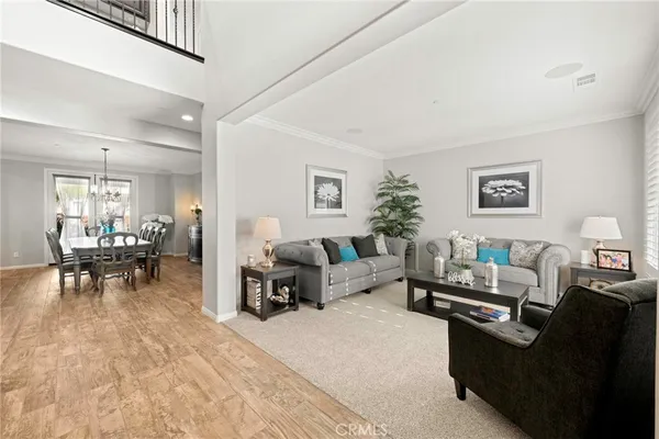 a living room with furniture and a dining room