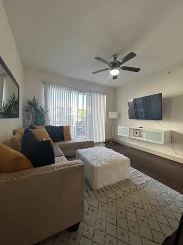 a living room with furniture and a flat screen tv