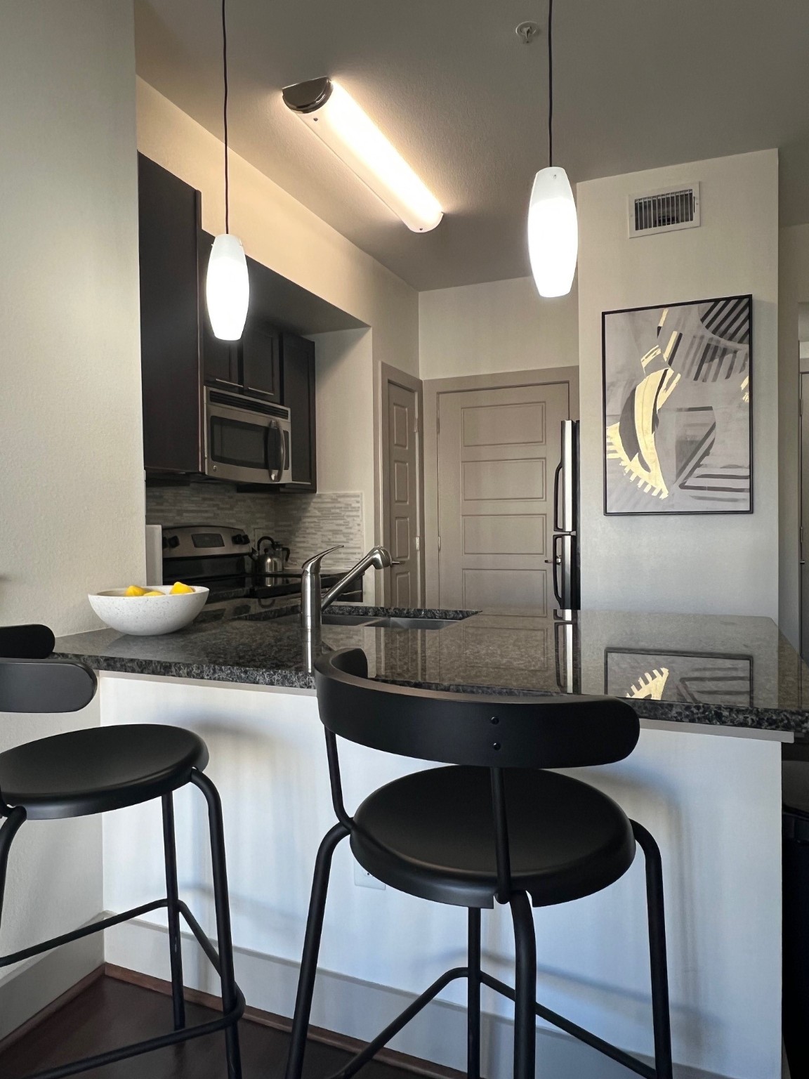 145 Heights Boulevard, Unit 363 Houston, TX 77007 - Photo 4 of 10 a kitchen with a table chairs and a refrigerator